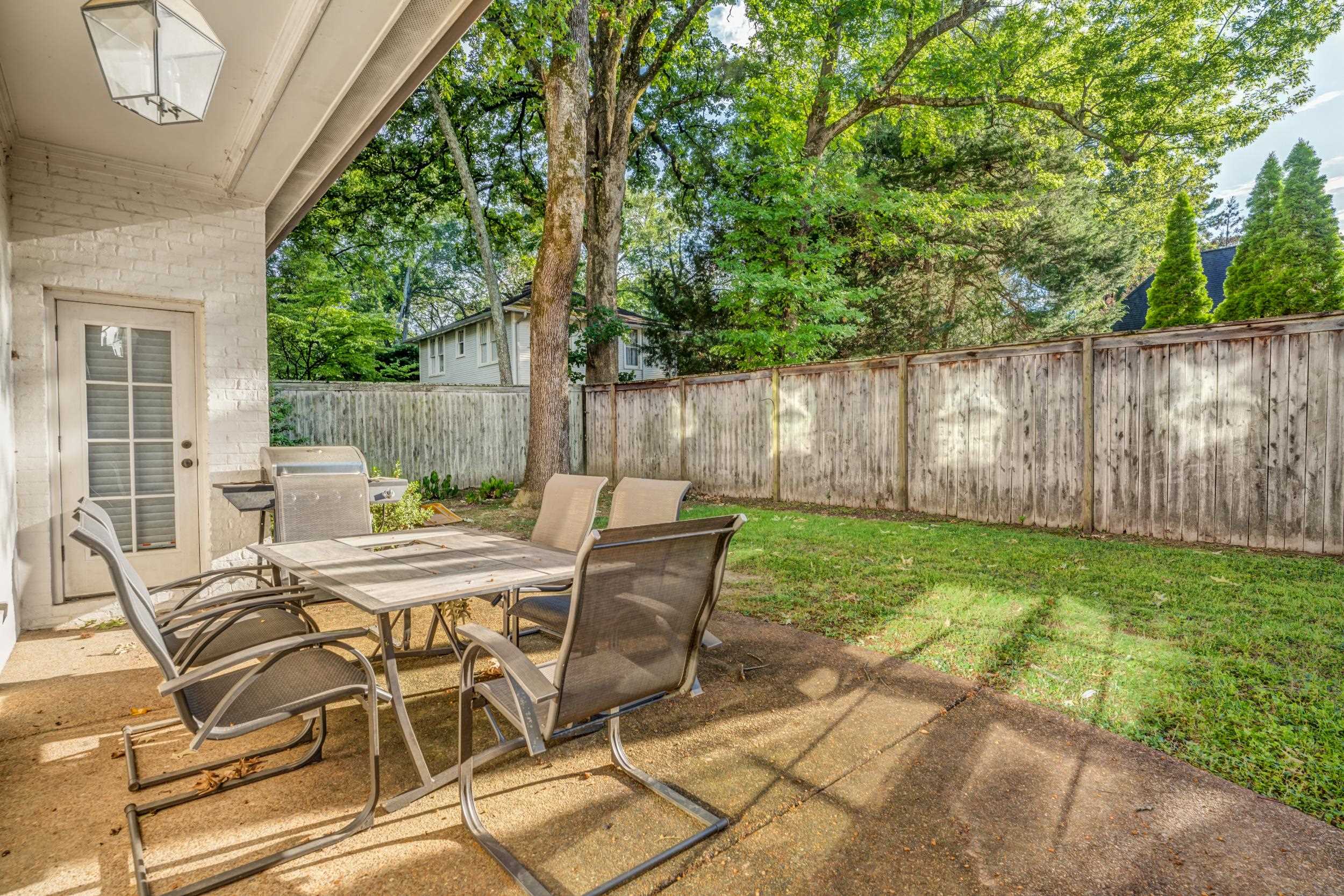 477 South Yates Road Memphis, TN 38120 - Photo 8 of 39 a view of a chairs and table in backyard of the house