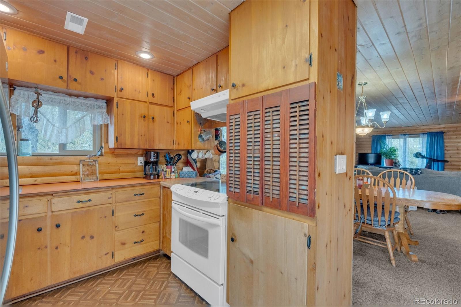 847 Timber Ridge Road Divide, CO 80814 - Photo 15 of 41 a kitchen with cabinets and chairs