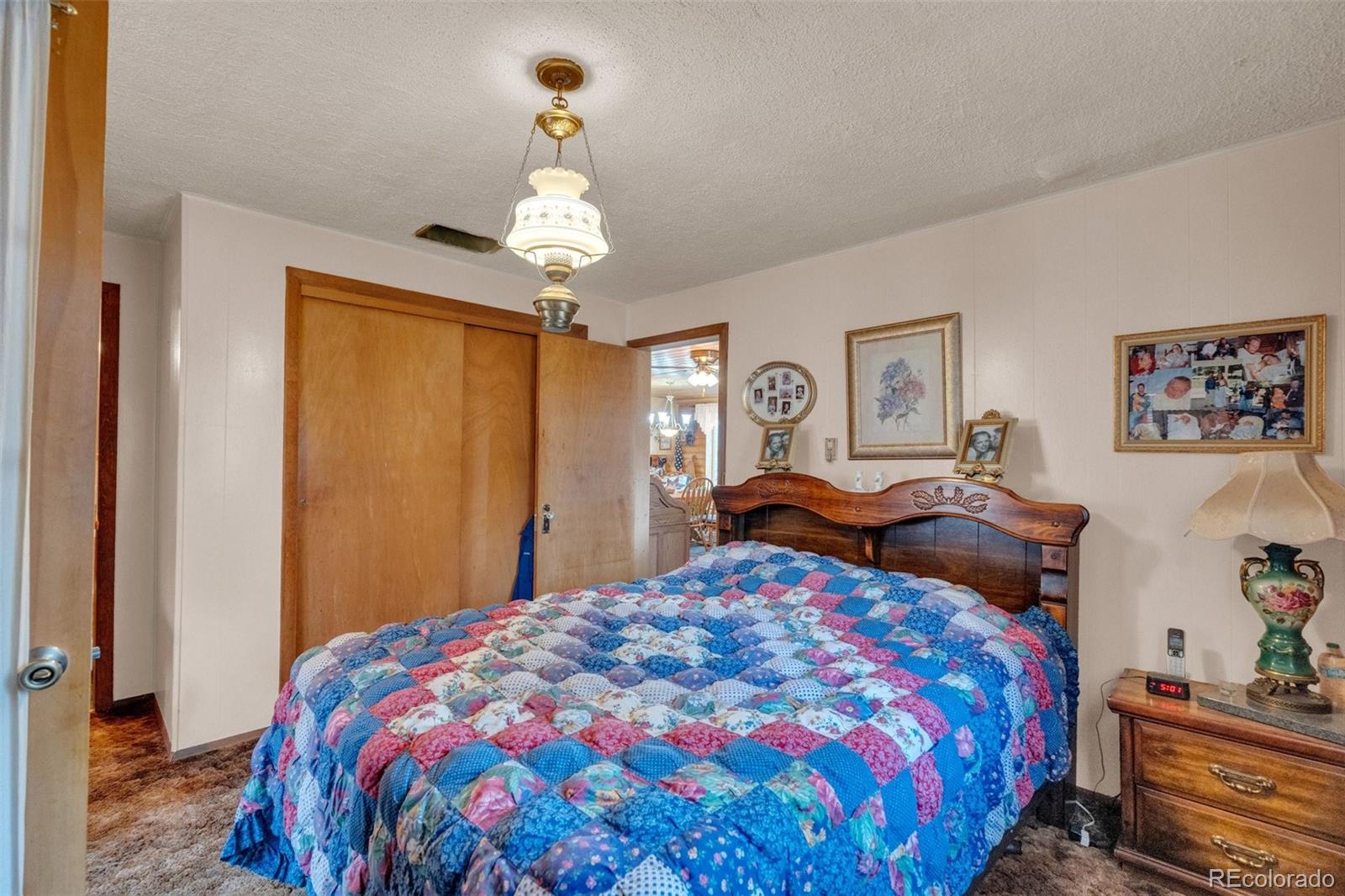 847 Timber Ridge Road Divide, CO 80814 - Photo 18 of 41 a bedroom with a bed and a chandelier
