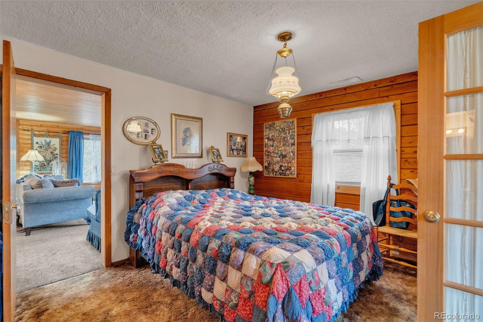 847 Timber Ridge Road Divide, CO 80814 - Photo 19 of 41 a bedroom with a bed and a large mirror