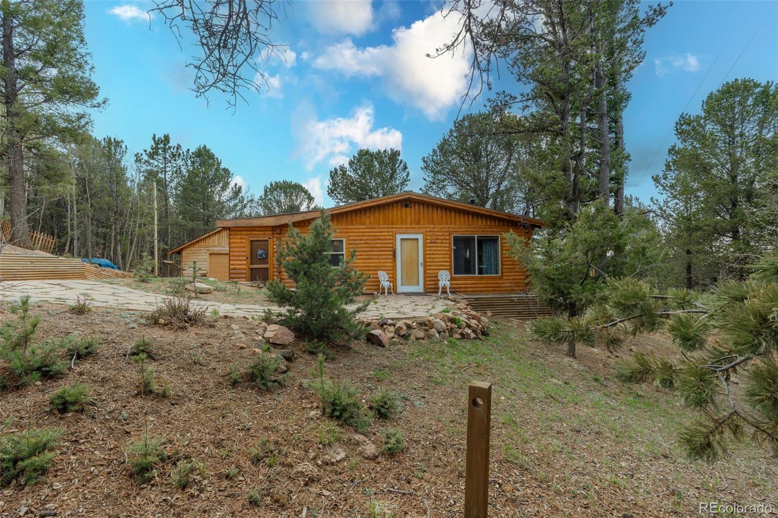 847 Timber Ridge Road Divide, CO 80814 - Photo 2 of 41 a view of a house with a yard