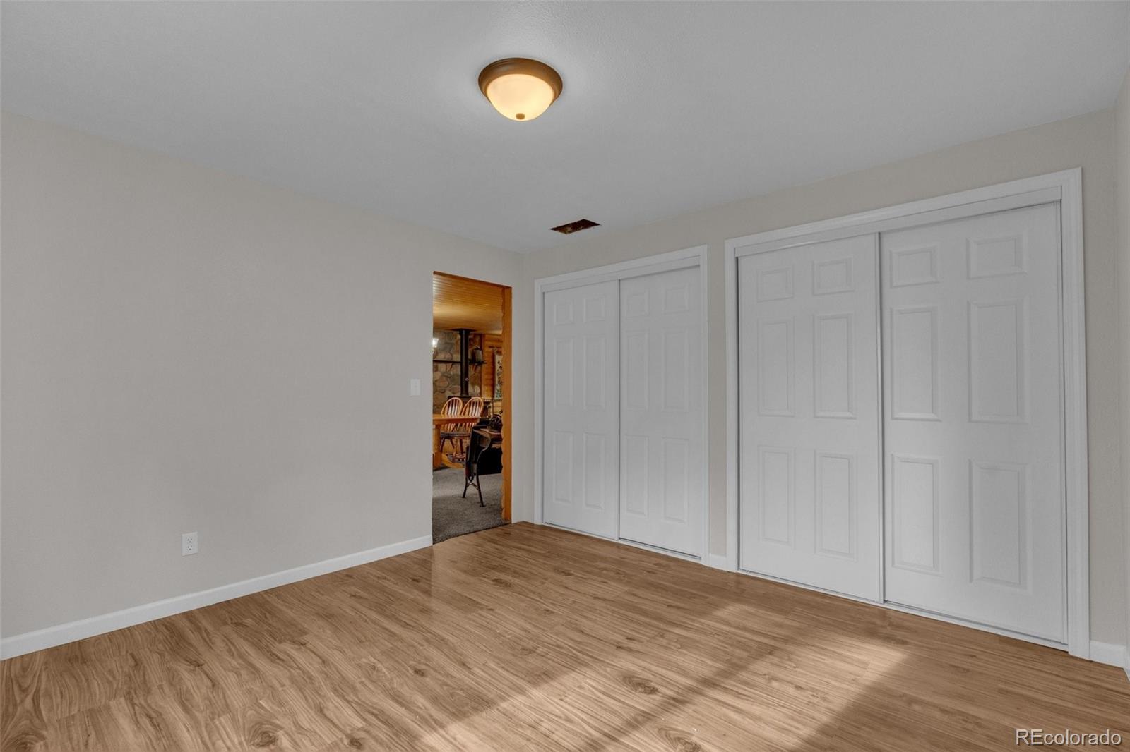 847 Timber Ridge Road Divide, CO 80814 - Photo 23 of 41 a view of an empty room with wooden floor