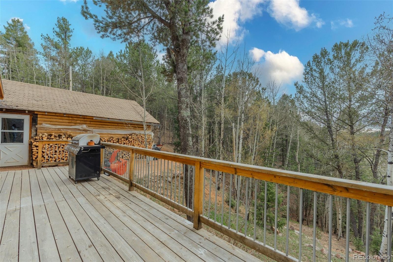 847 Timber Ridge Road Divide, CO 80814 - Photo 27 of 41 a view of a balcony with wooden floor and outdoor space