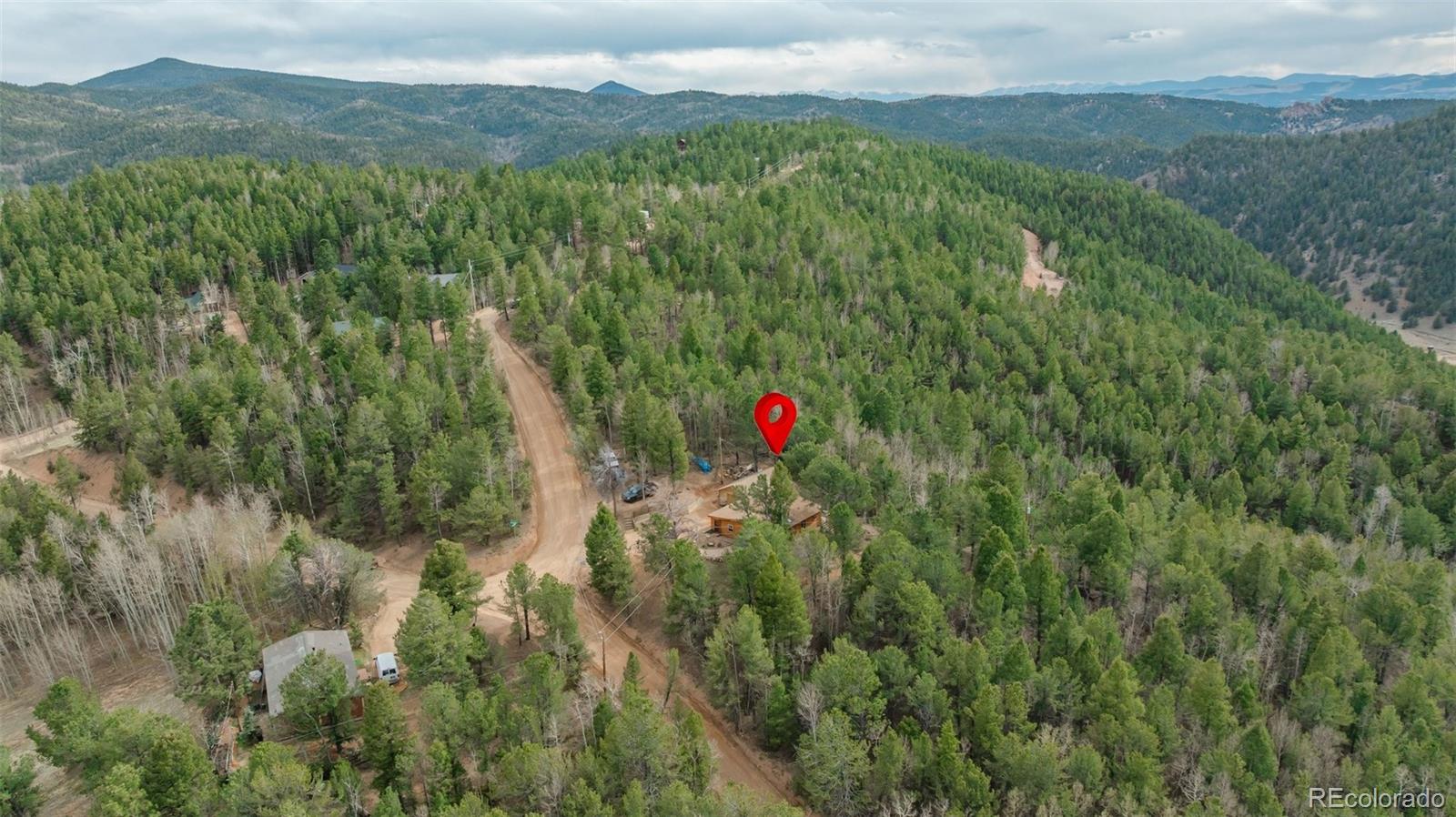847 Timber Ridge Road Divide, CO 80814 - Photo 32 of 41 a view of a lush green hillside and a houses