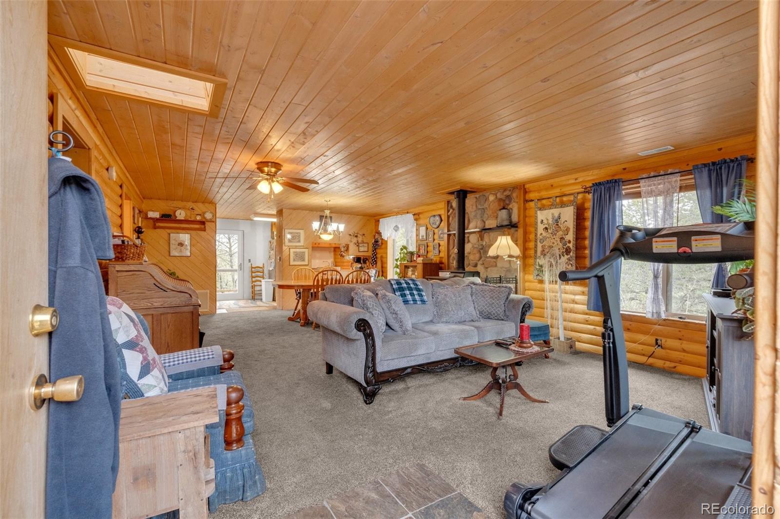 847 Timber Ridge Road Divide, CO 80814 - Photo 4 of 41 a living room with furniture a couch and chandelier