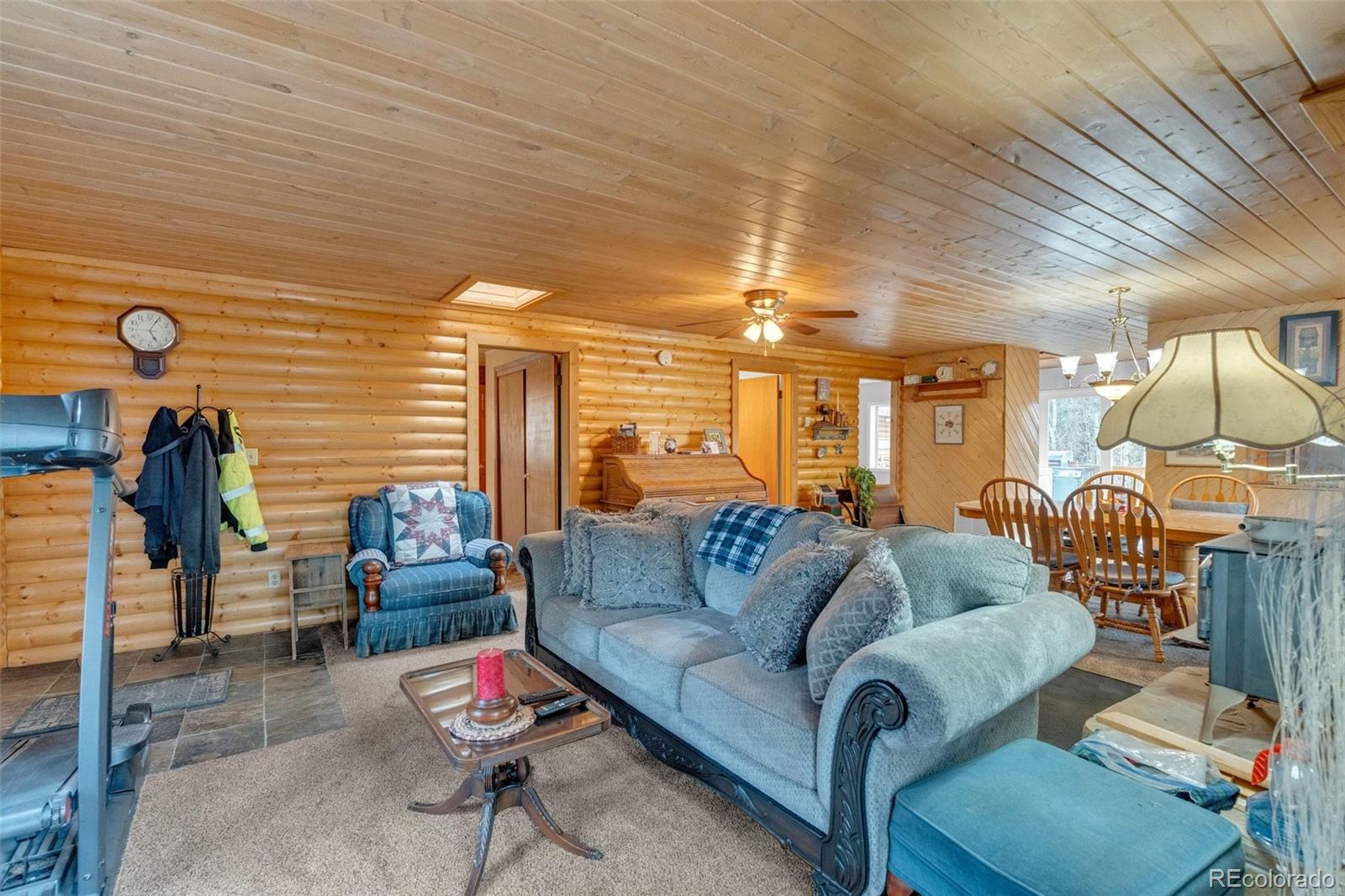847 Timber Ridge Road Divide, CO 80814 - Photo 7 of 41 a living room with furniture gym equipment and a chandelier
