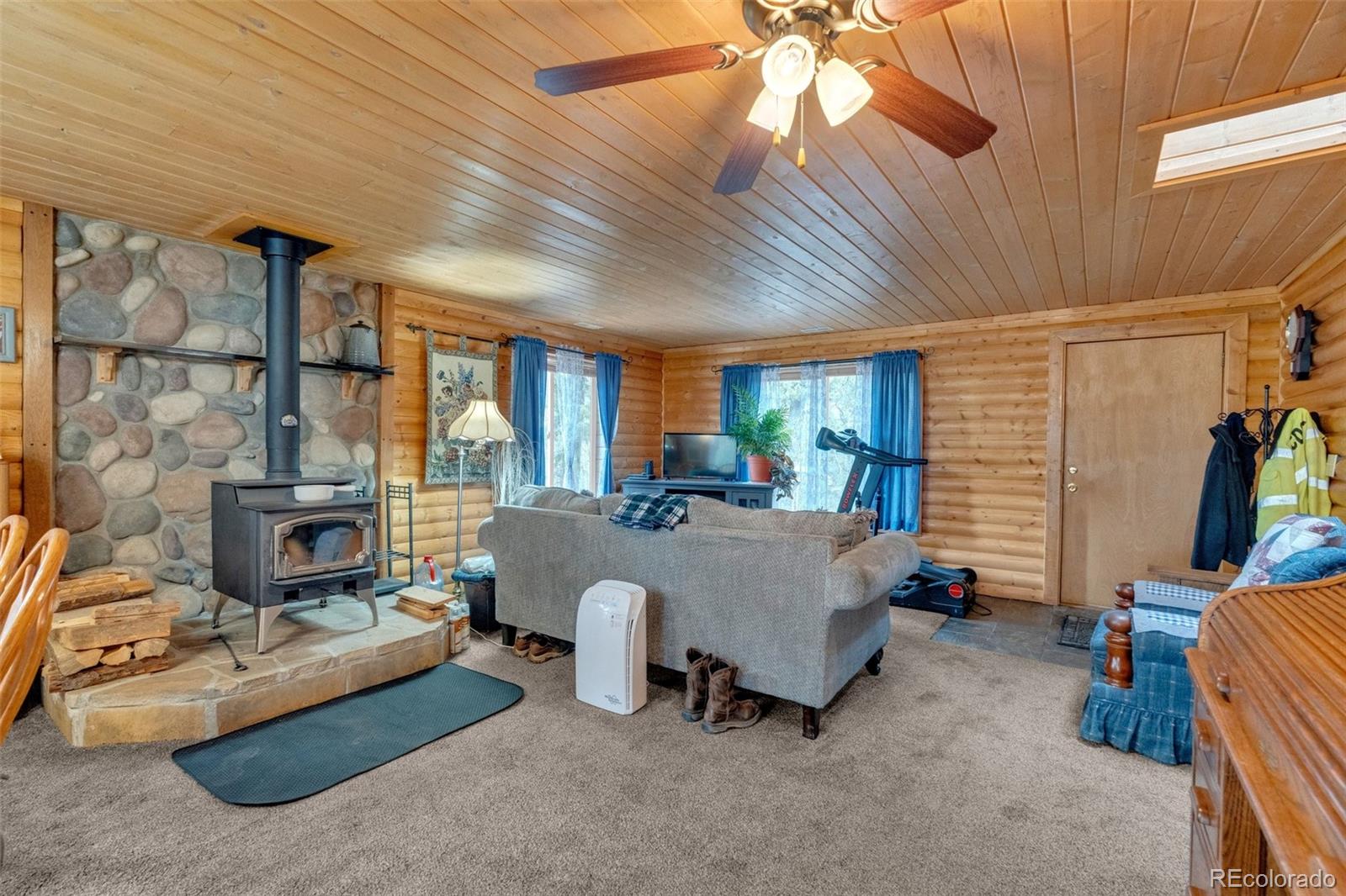 847 Timber Ridge Road Divide, CO 80814 - Photo 8 of 41 a bed room with a bed and a chandelier