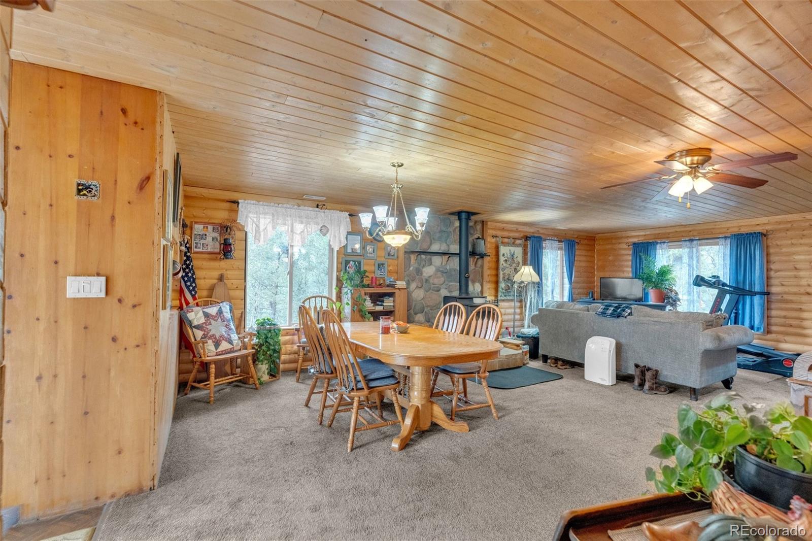 847 Timber Ridge Road Divide, CO 80814 - Photo 10 of 41 a outdoor space with lots of tables a chandelier and couches