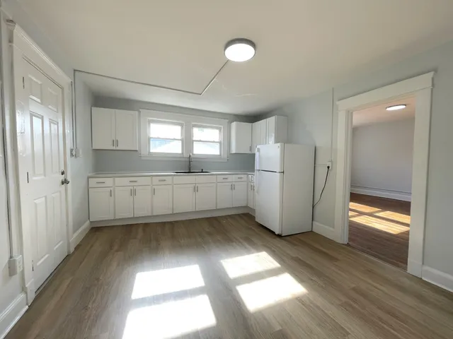 a kitchen with a refrigerator and a sink