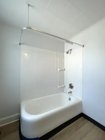 a bathroom with a tub and shower