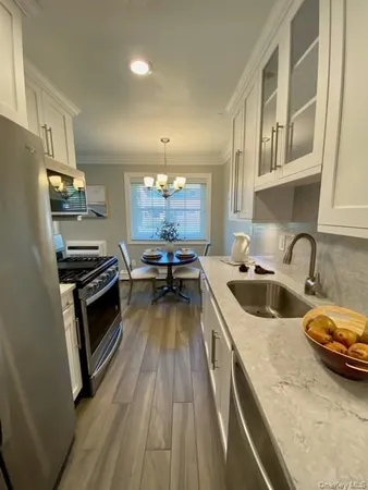 a kitchen with granite countertop a stove and a sink