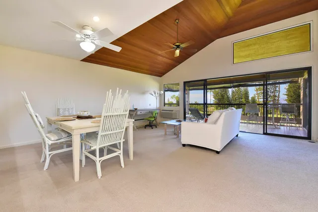 a view of a dining room with furniture and a chandelier fan