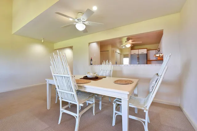 a view of a dining room with furniture and chandelier fan