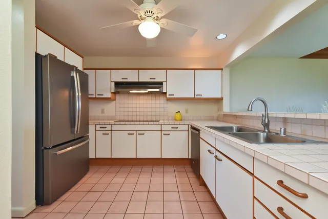 a kitchen with granite countertop cabinets stainless steel appliances a sink and a counter top space