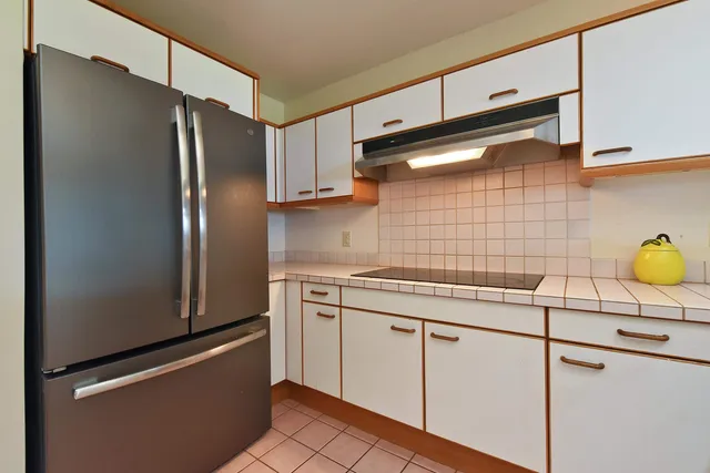 a kitchen with stainless steel appliances kitchen island granite countertop a sink and cabinets