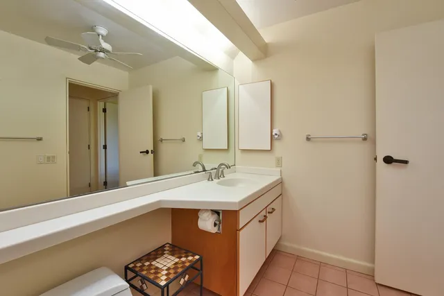 a bedroom with a bed and a painting on the wall