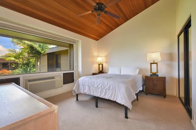 a bedroom with a bed and a lamp