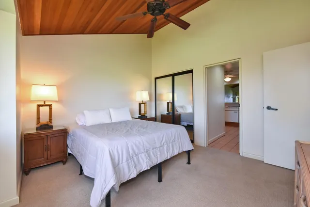 a view of a hallway with couch and a potted plant