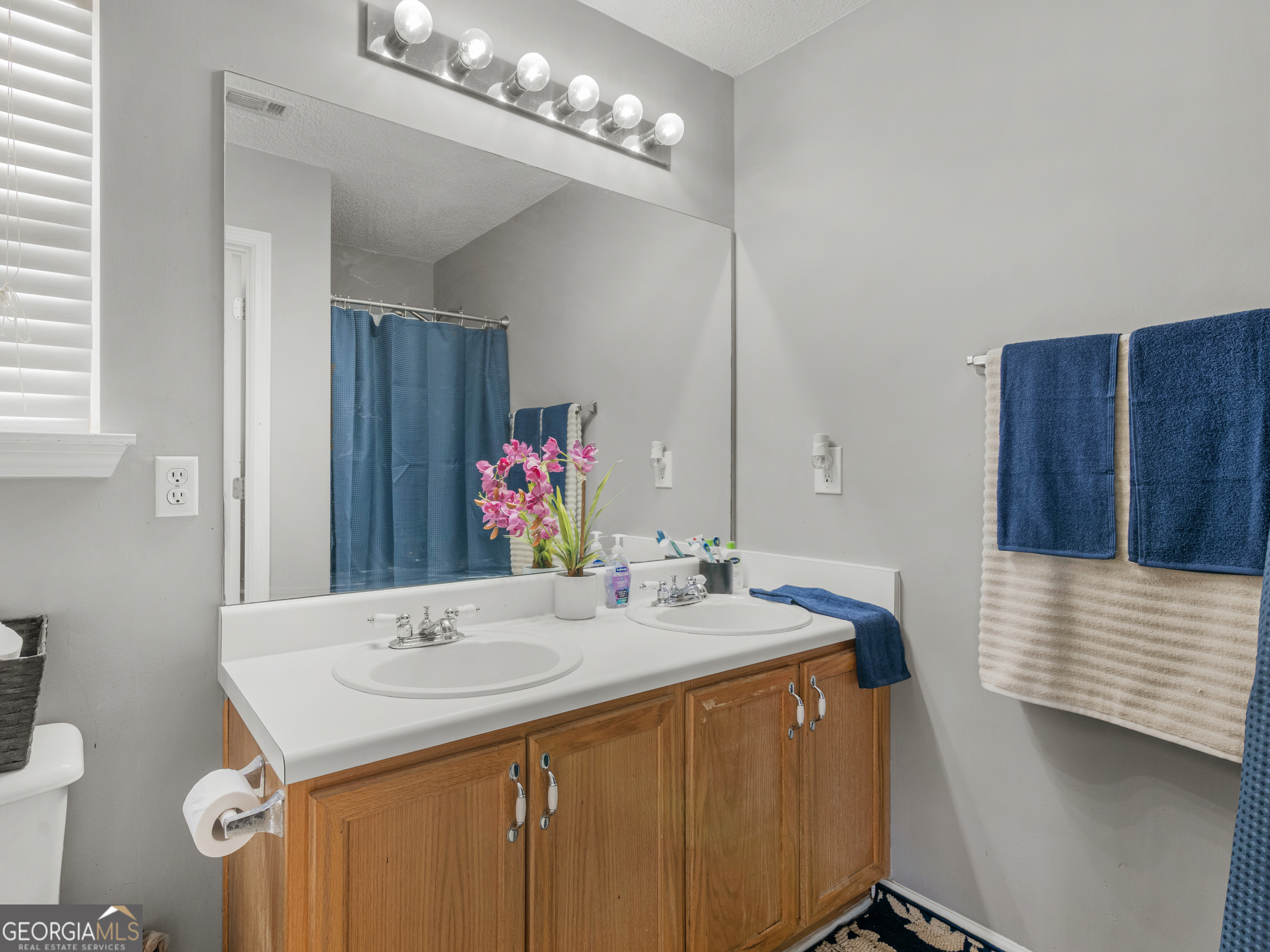 3370 Waggoner Place Rex, GA 30273 - Photo 15 of 25 a bathroom with a sink and a mirror
