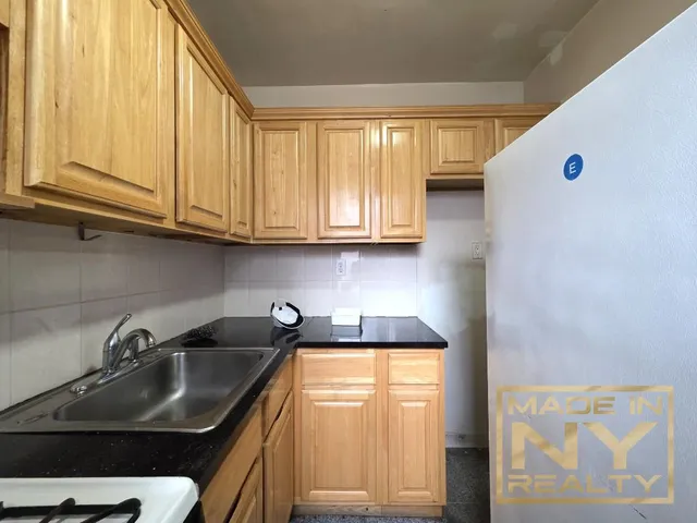 a kitchen with stainless steel appliances granite countertop a sink and a white cabinets