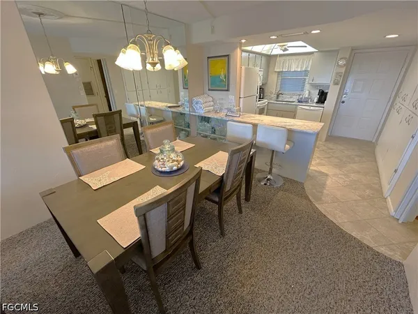 a view of a dining room with furniture and a chandelier