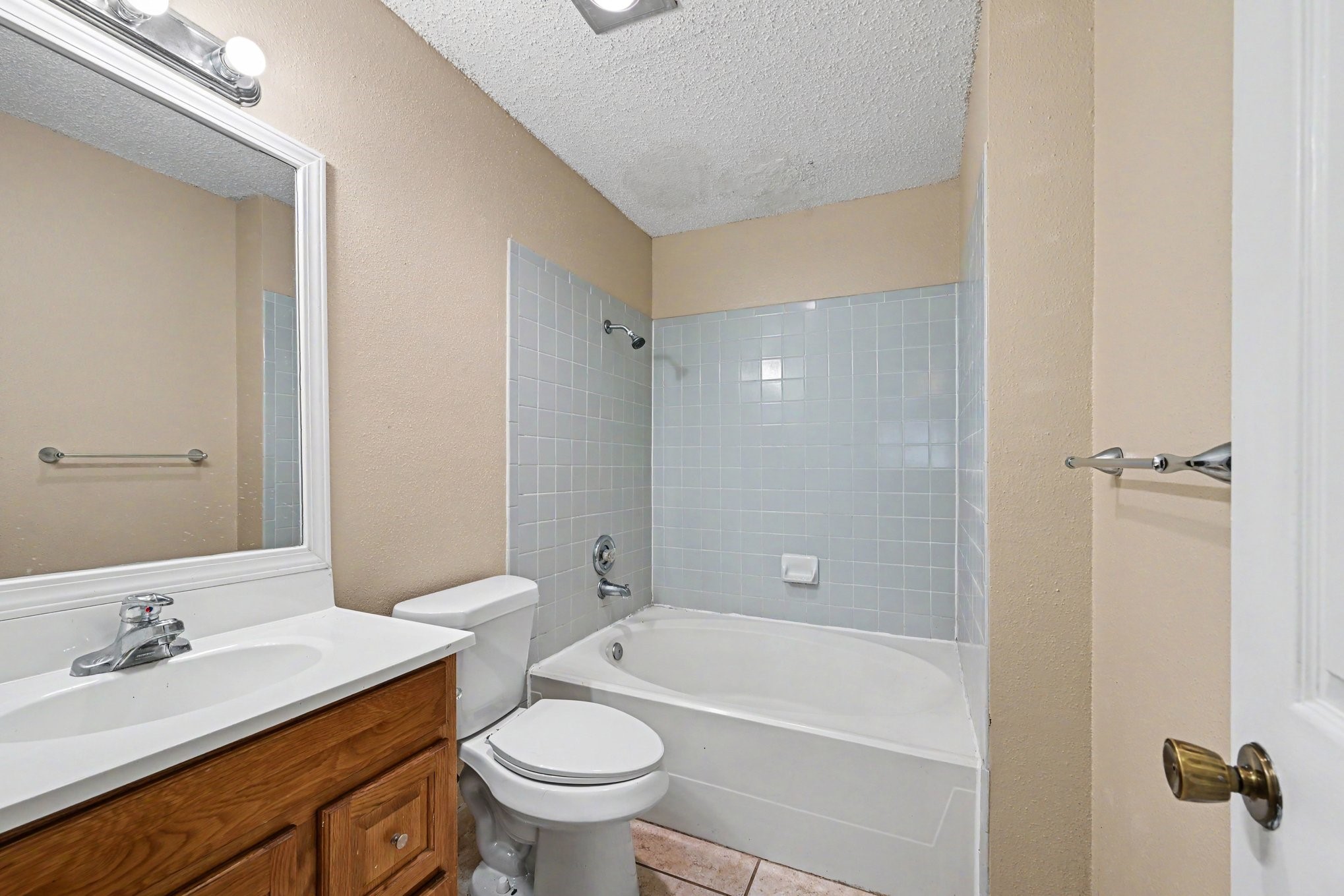 8406 Forest Ridge Drive San Antonio, TX 78239 - Photo 19 of 33 a bathroom with a granite countertop sink a toilet and shower
