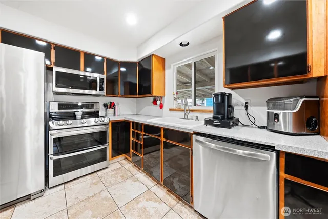 a kitchen with stainless steel appliances a stove and more cabinets