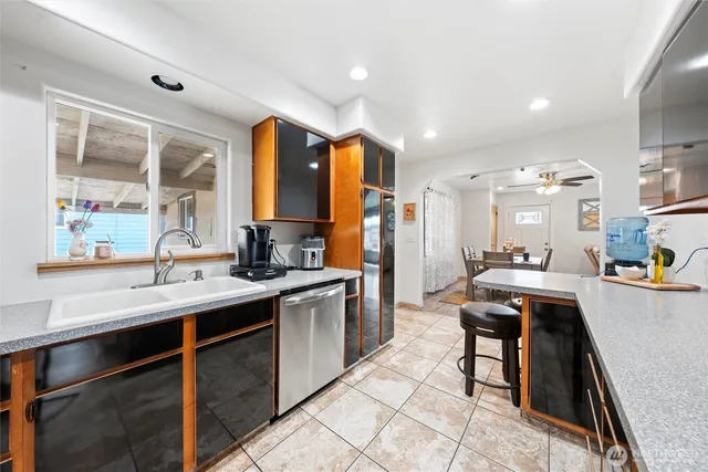 a kitchen with stainless steel appliances granite countertop sink stove and cabinets