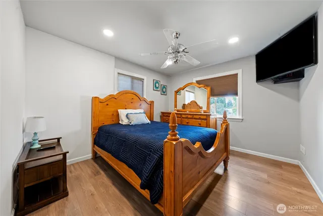 a bedroom with a bed and wooden floor