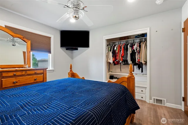 a bedroom with a bed and a flat screen tv