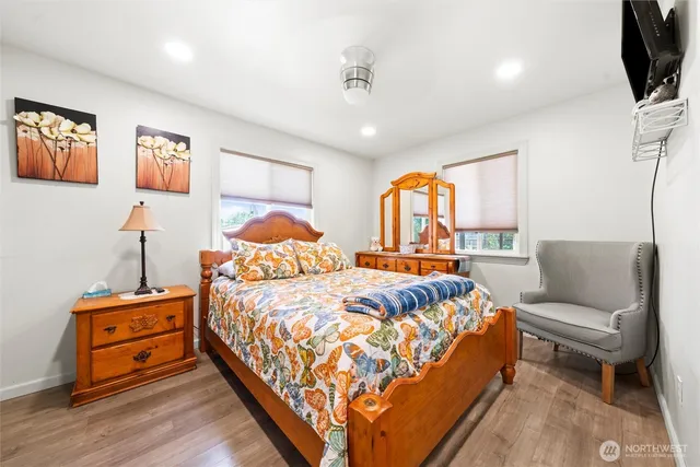 a bedroom with a bed a couch and dresser