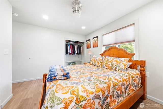 a bedroom with a bed and a painting on the wall