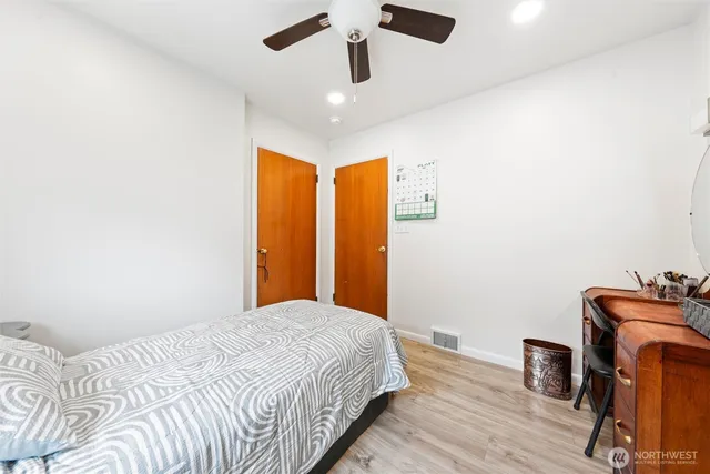 a bedroom with a bed and wooden floor