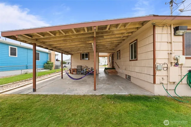a view of a chair and table in backyard