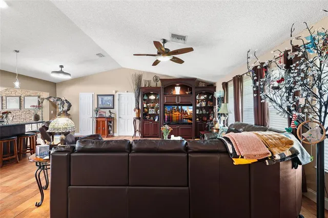 a view of a patio with table and chairs potted plants with wooden floor and fence