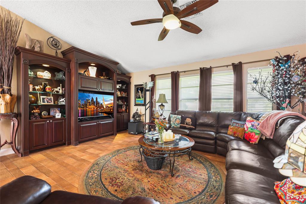 9700 Northwest 28th Street Hollywood, FL 33024 - Photo 15 of 76 a living room with furniture and a flat screen tv