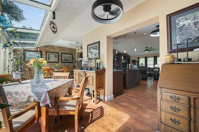 a kitchen with stainless steel appliances kitchen island granite countertop a table and chairs in it