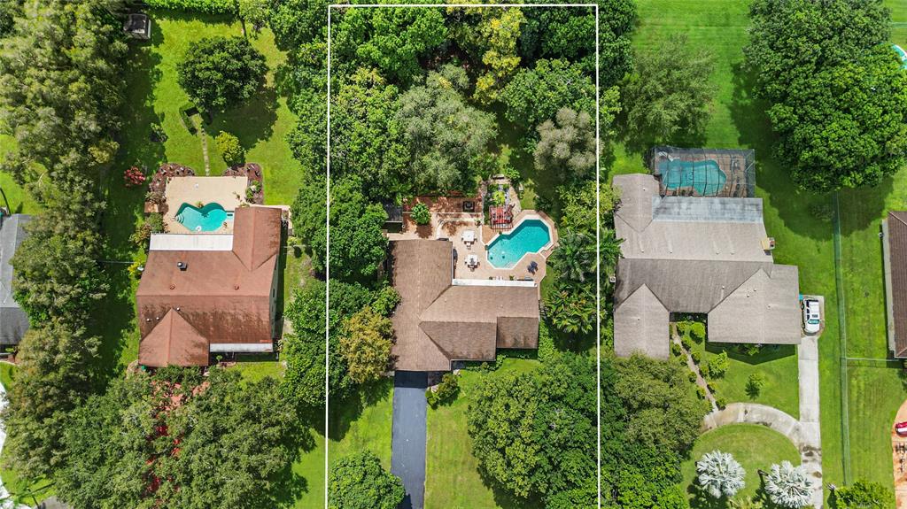 9700 Northwest 28th Street Hollywood, FL 33024 - Photo 2 of 76 an aerial view of a house with a yard and lake view