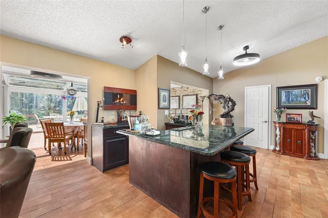 a kitchen with stainless steel appliances granite countertop a stove refrigerator and cabinets