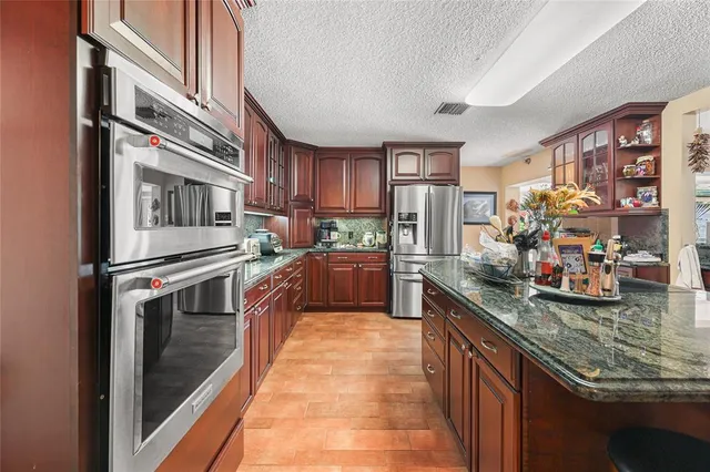 a view of a livingroom with wooden floor and furniture