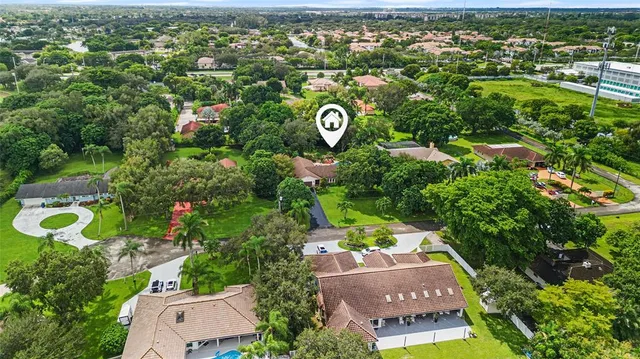 an aerial view of residential house with outdoor space and swimming pool
