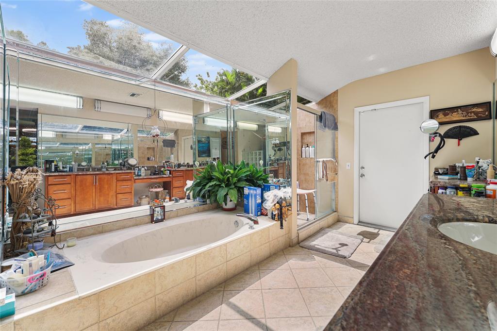 9700 Northwest 28th Street Hollywood, FL 33024 - Photo 34 of 76 a spacious bathroom with a tub sink and mirror