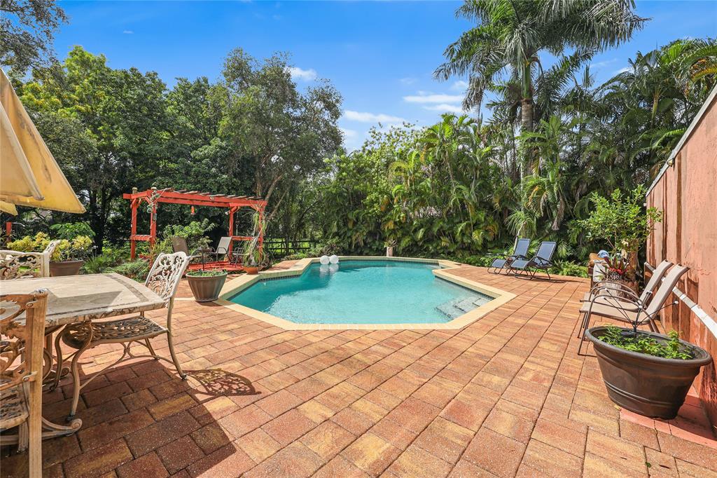 9700 Northwest 28th Street Hollywood, FL 33024 - Photo 40 of 76 a view of a swimming pool with sitting area