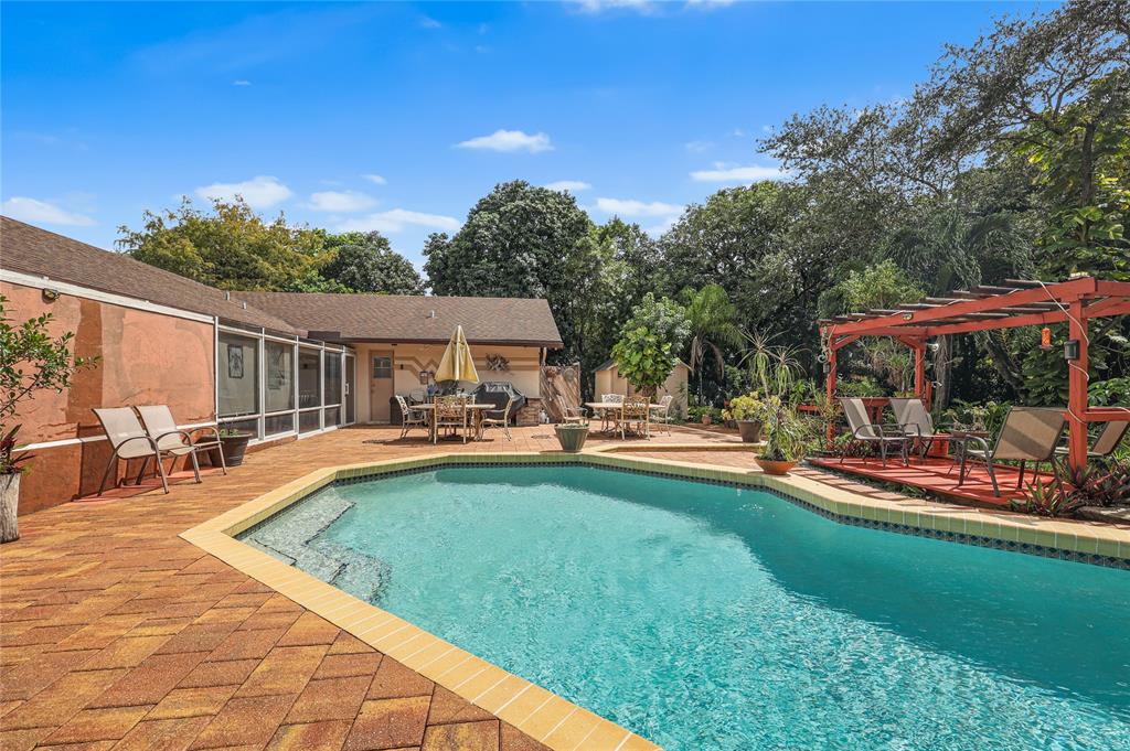 9700 Northwest 28th Street Hollywood, FL 33024 - Photo 42 of 76 a view of a house with swimming pool and sitting area
