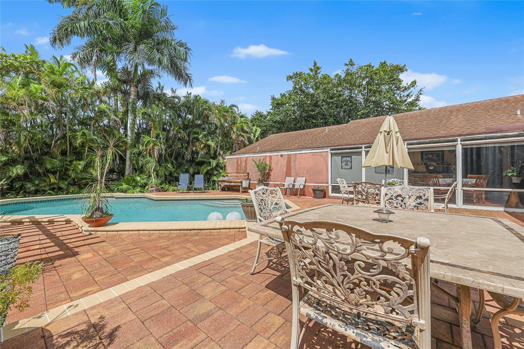 9700 Northwest 28th Street Hollywood, FL 33024 - Photo 43 of 76 a view of a house with swimming pool and sitting area