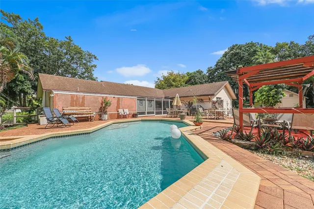 an aerial view of a house with a swimming pool