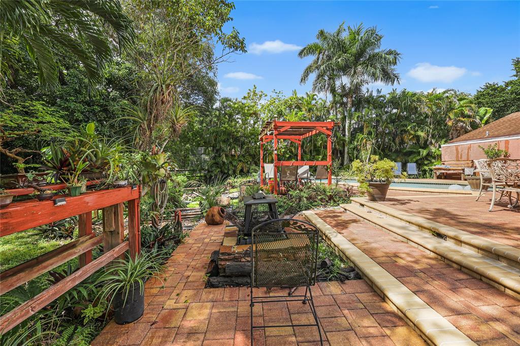 9700 Northwest 28th Street Hollywood, FL 33024 - Photo 46 of 76 a view of a garden with an outdoor seating