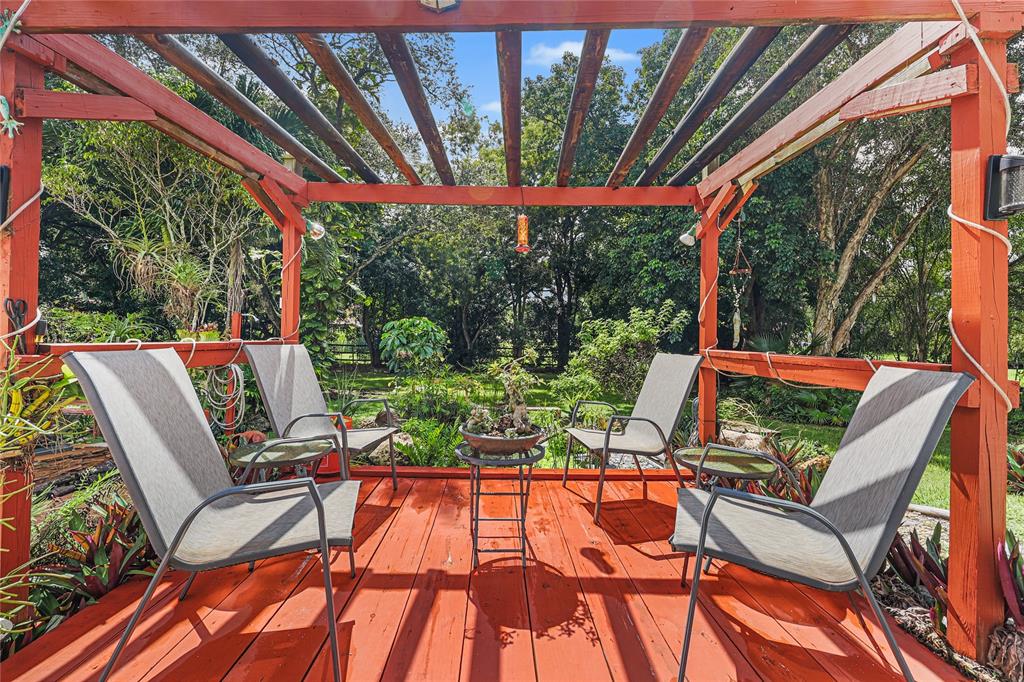 9700 Northwest 28th Street Hollywood, FL 33024 - Photo 47 of 76 a patio with yard glass top table and chairs