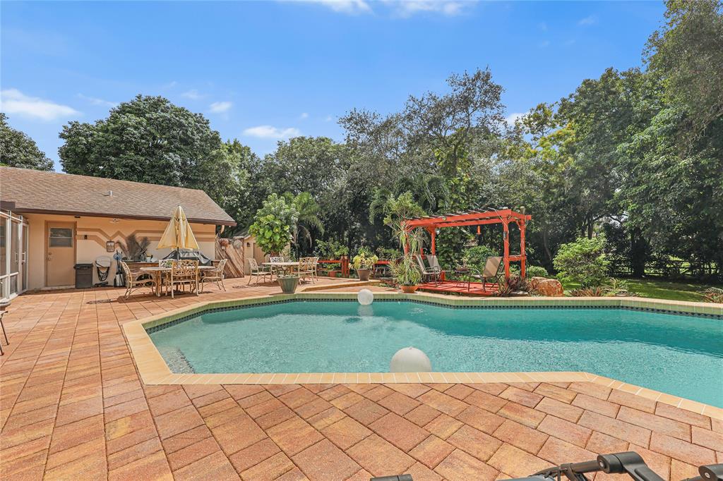 9700 Northwest 28th Street Hollywood, FL 33024 - Photo 49 of 76 a view of a house with swimming pool and sitting area
