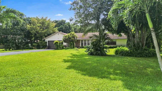 a front view of house with yard and green space